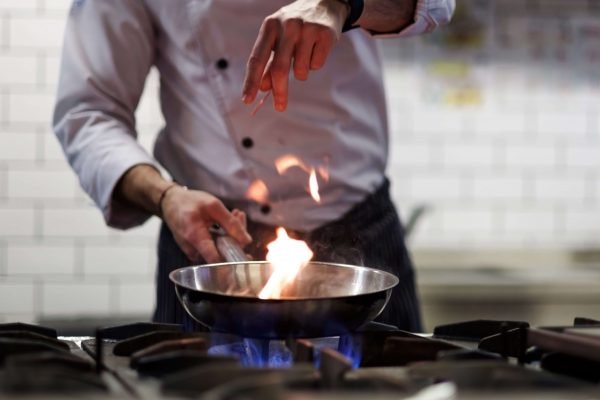 man cooking at home with gas propane cayman