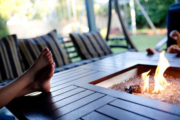 Person Relaxing By Propane Fire Pit Cayman Islands