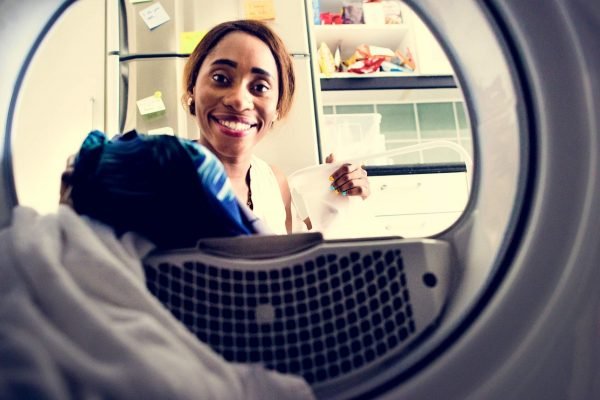 happy woman using propane powered dryer cayman islands